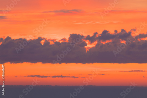 The sunset or sunrise. The cloudy sky cloured in red  orange  rose  scarlet  crimson  purple  violet and blue bright and vivid coloures in the evening or in the morning