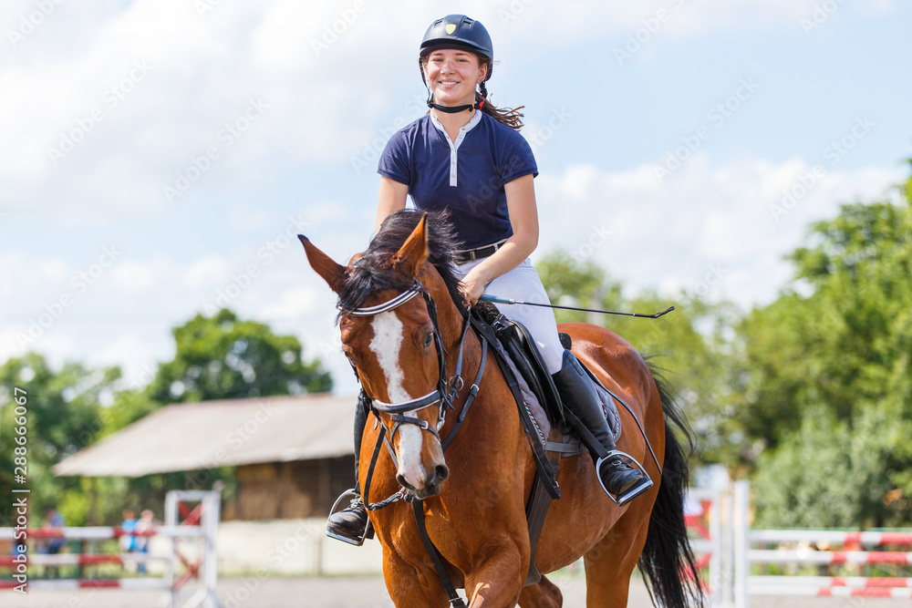 Young female horse rider on equestrian sport event Young female horse rider on equestrian sport event