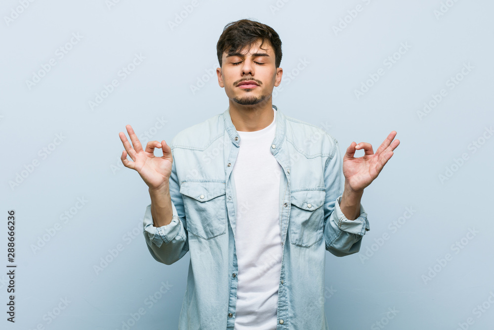 Young hispanic cool man relaxes after hard working day, she is performing yoga. Young hispanic cool man relaxes after hard working day, she is performing yoga.