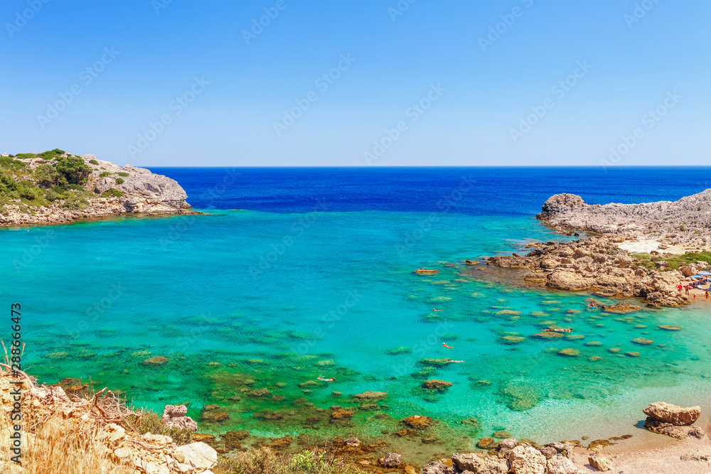 Sea skyview landscape photo Ladiko bay near Anthony Quinn bay on Rhodes island, Dodecanese, Greece. Panorama with nice sand beach and clear blue water. Famous tourist destination in South Europe