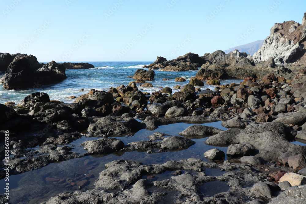 Rocks in the ocean at low tide in Los Gigantes, Spain