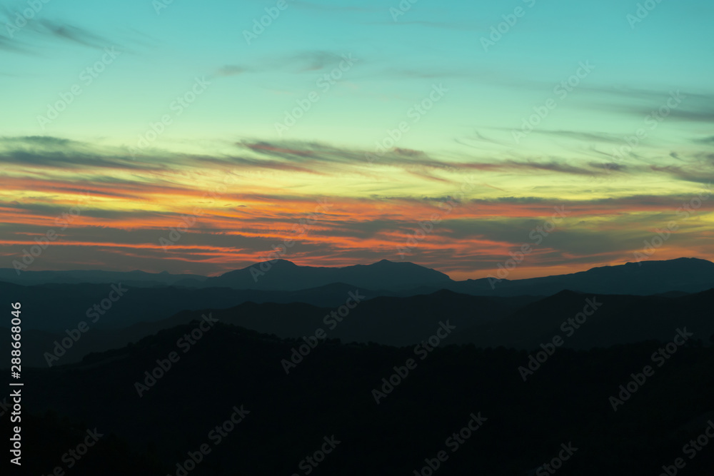 Fototapeta premium Panoramic mountain and dramatic sky sundown background