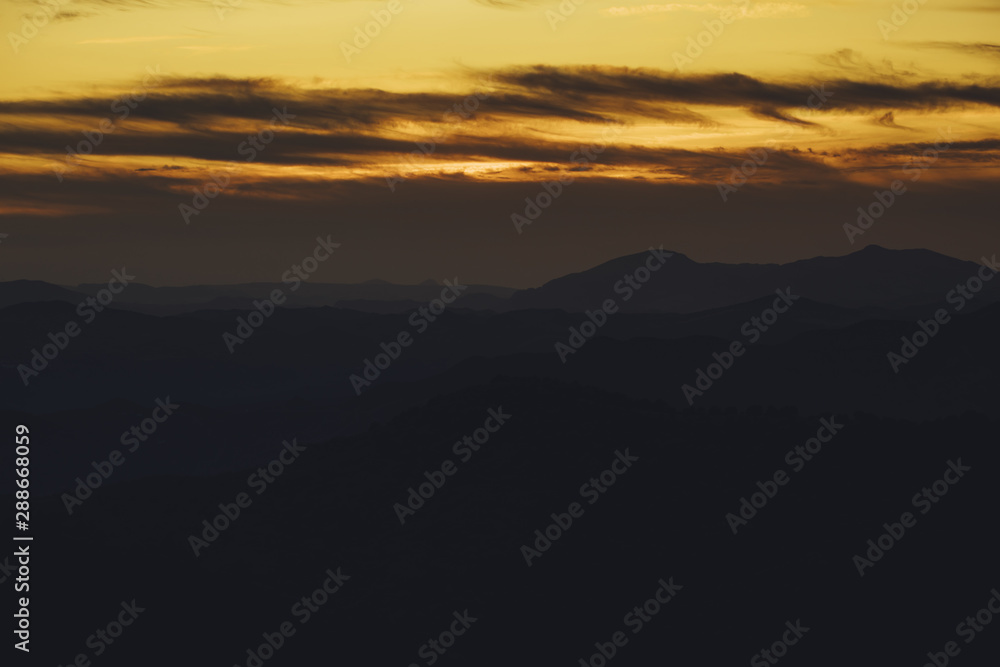 Panoramic mountain and dramatic sky sundown background in golden
