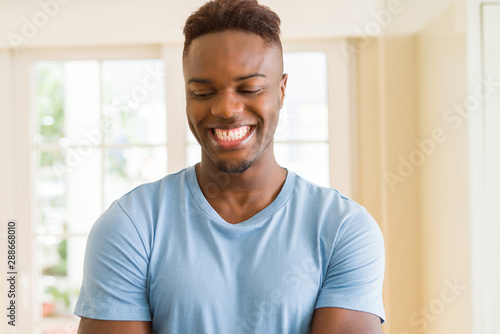 Handsome african young man smiling cheerful with crossed arms