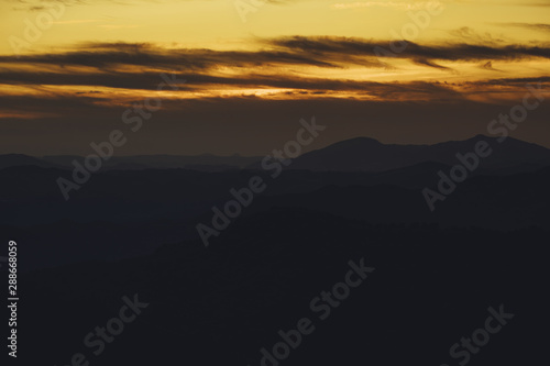 Panoramic mountain and dramatic sky sundown background in golden