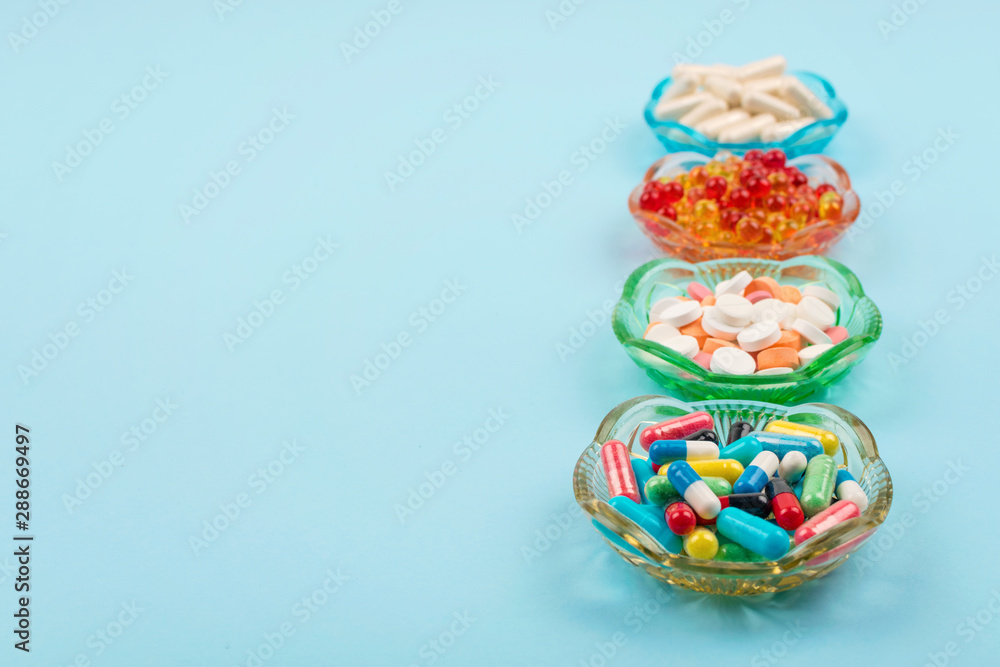 Cold medicine, health care, traditional medicine and flu concept. Various multi-colored pills and capsules, treatment of colds, flu and runny