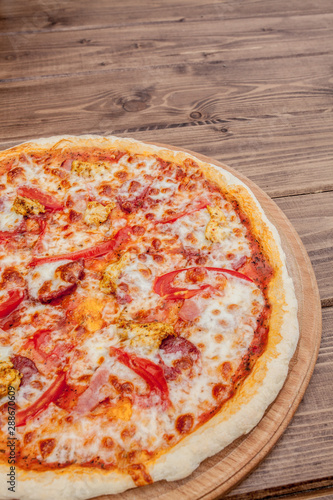 Pizza with Mozzarella cheese, salami, Tomatoes, pepper, Spices. Italian pizza