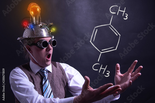 Nerd presenting handdrawn chemical formula of formic Xylene photo