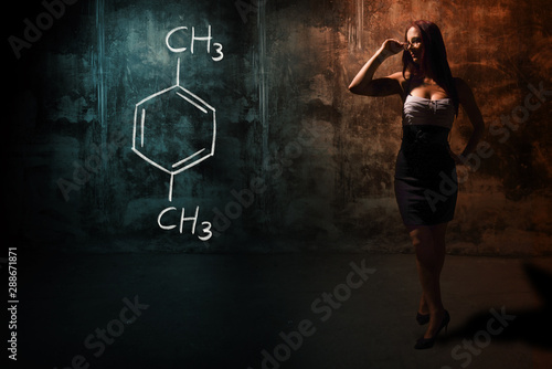 Sexy girl or secretary or female student presenting handdrawn chemical formula of Xylene