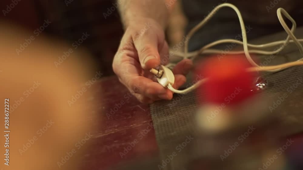 Hand pressing on a button to switch on a lamp. Hand pressing on a button to switch on a lamp.