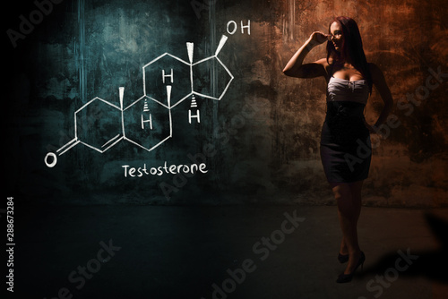 Sexy girl or secretary or female student presenting handdrawn chemical formula of testosterone photo