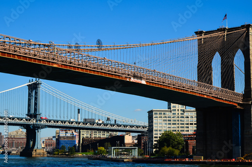 NEW YORK, NY - Historic Brooklyn Bridge and New York City seen from Brooklyn Bridge Park. Spanning the East River, this 1883 bridge connects Manhattan and Brooklyn. © Olena