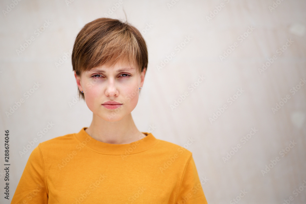 front portrait of beautiful young woman with serious face expression against white background front portrait of beautiful young woman with serious face expression against white background