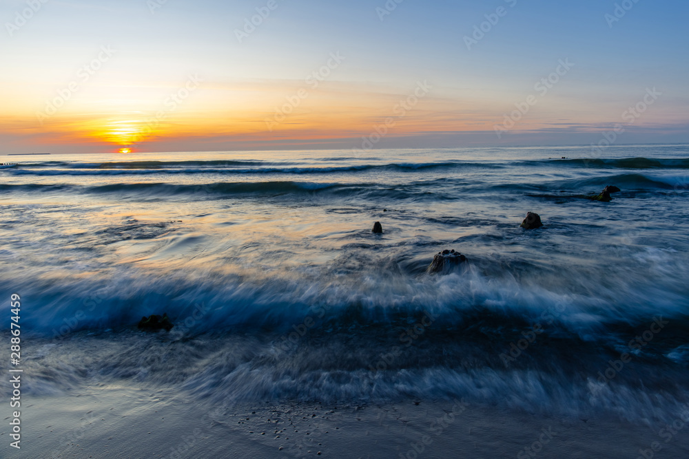 beautiful natural scene, sunset by the sea and long exposure waves