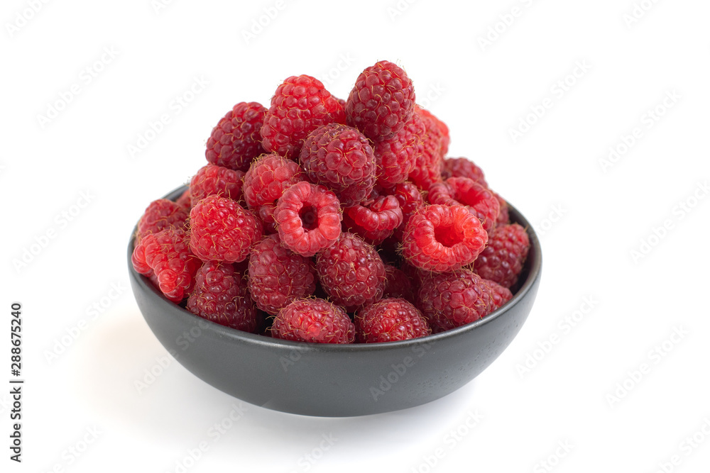 Fresh raspberries in dark bowl isolated on white background Fresh raspberries in dark bowl isolated on white background