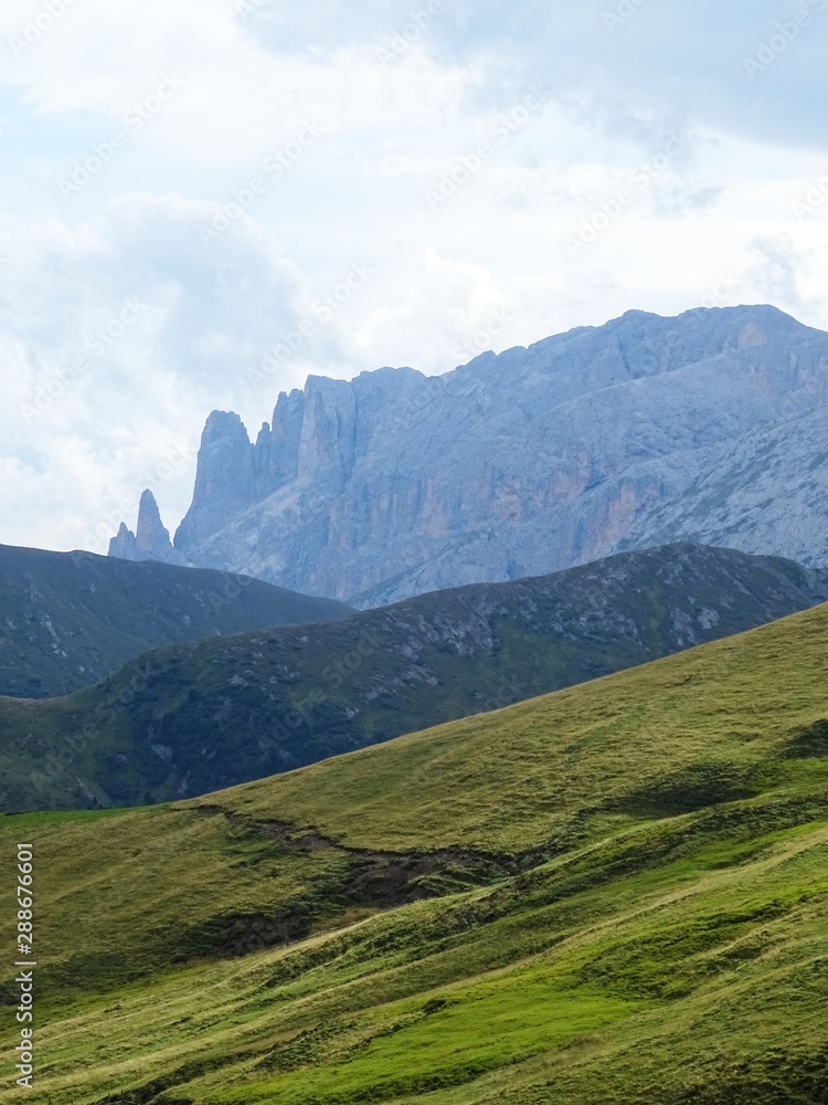 Naklejka premium Some peaks of the Dolomites immersed in the nature of the Val di Fassa, near the town of Canaze, Italy - August 2019.
