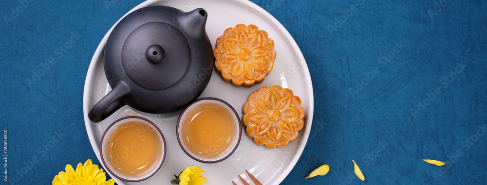 Minimal simplicity layout moon cakes on blue background for Mid-Autumn Festival, creative food design concept, top view, flat lay, copy space. Minimal simplicity layout moon cakes on blue background for Mid-Autumn Festival, creative food design concept, top view, flat lay, copy space.