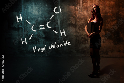 Sexy girl or secretary or female student presenting handdrawn chemical formula of vinyl chloride photo