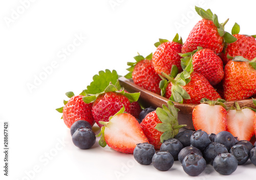 A bowl set of beautiful and delicious strawberry and blueberry isolated on white background  close up  copy space  clipping path  cut out.