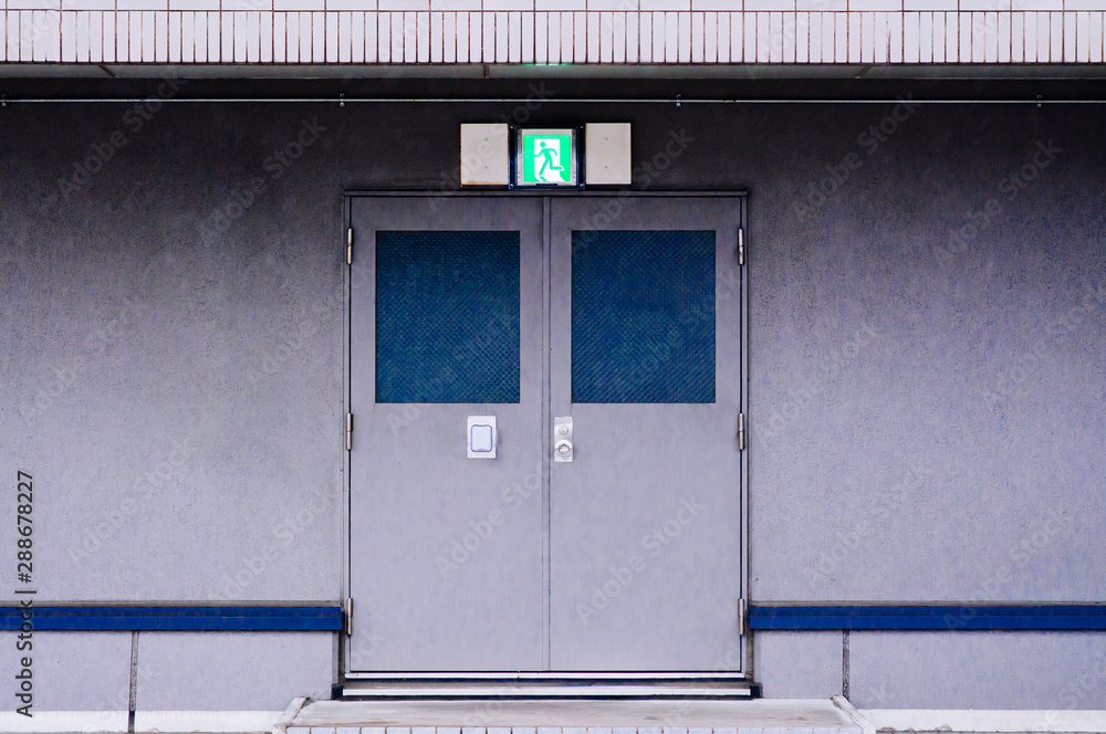 Fototapeta premium Building Emergency Exit with metal iron door with fire exit sign