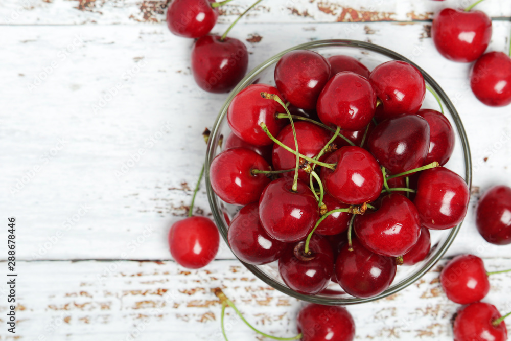 A small glass bowl with ripe fresh cherry A small glass bowl with ripe fresh cherry