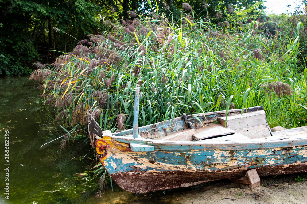 Old abandoned wrecked fishing boat at a lake Old abandoned wrecked fishing boat at a lake