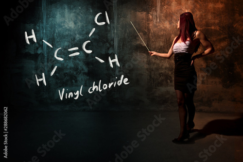 Sexy girl or secretary or female student presenting handdrawn chemical formula of vinyl chloride photo