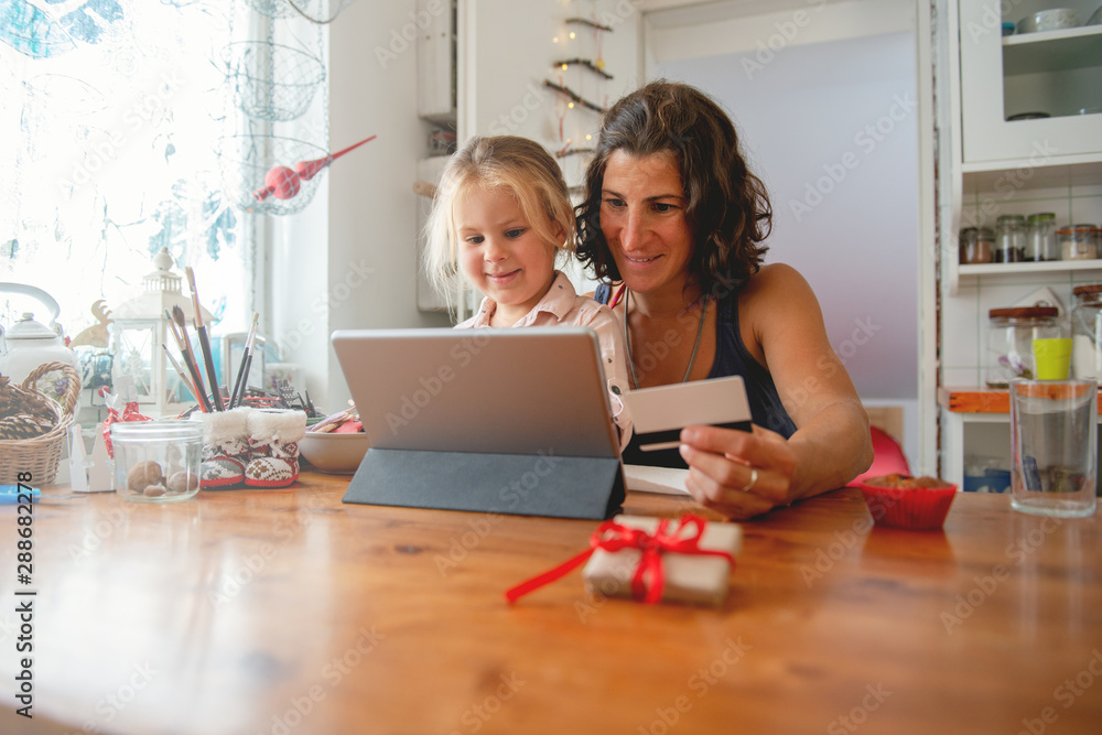 Mother paying with credit card from home Mother paying with credit card from home