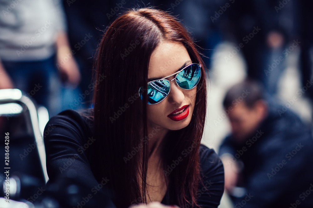 close up. stylish woman biker riding a motorcycle close up. stylish woman biker riding a motorcycle