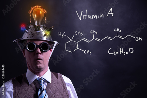 Nerd presenting handdrawn chemical formula of Vitamin A
