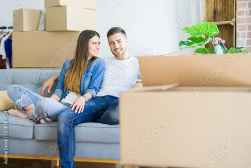 Young couple in love relaxing sitting on the sofa at new home, smiling happy for moving to new apartment © Krakenimages.com