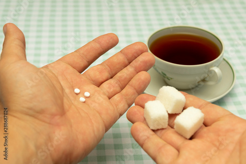 Canvastavla three small sweetener tablets replacing three teaspoons of sugar in hand for add