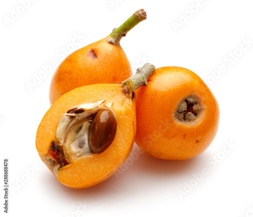 Half and whole ripe loquat fruits isolated on white background