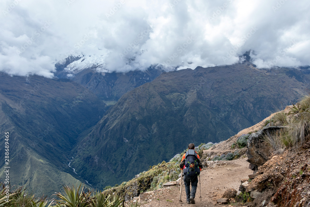 Young hiker man trekking with backpack in Peruvian Andes mountains, Peru, South America