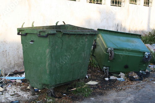 Dirty and messed up public trash cans garbage tanks showing the unaware social and individual attitude   mentality. Third world country pattern and pollution