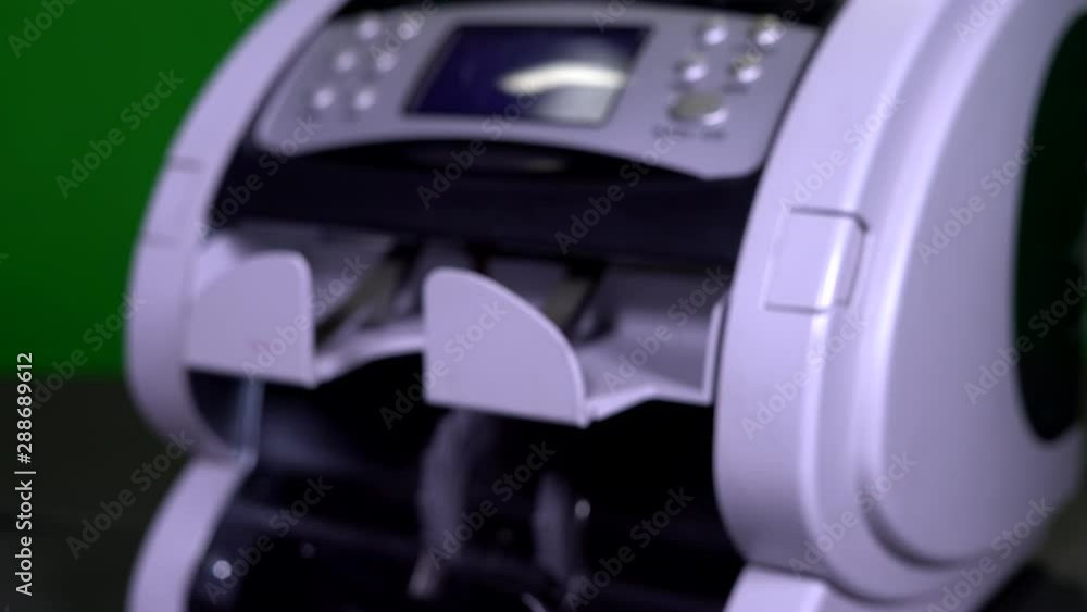 Female transfers counting bills, money to a man. money counter machine on the background. US dollar. Currency, detector counting Female transfers counting bills, money to a man. money counter machine on the background. US dollar. Currency, detector counting