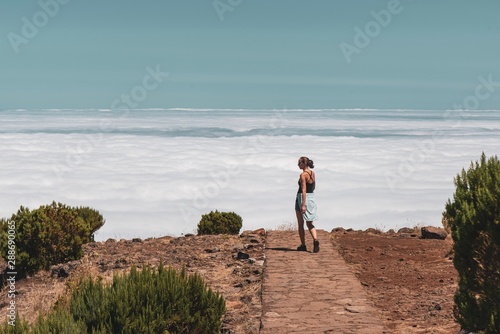 Young woman is Walking into the clouds