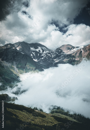 alpine landscape with peaks covered by snow and clouds in the alps in austria © Maximilian