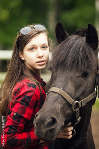 Young girl with the black horse