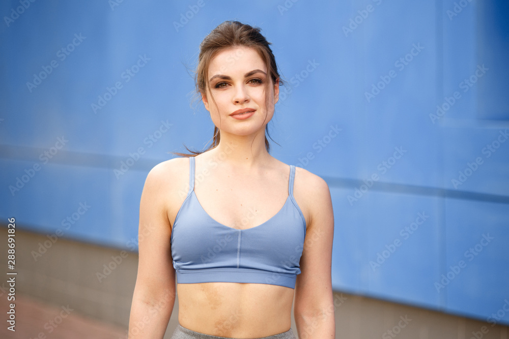Summer outdoor training. Sporty woman doing gym in the park