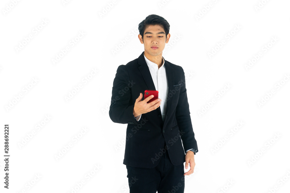 Handsome young businessman Asian caucasian wear a black suit with black hair, be a smile and standing smart poses. Hold and use a smartphone. On white background. Handsome young businessman Asian caucasian wear a black suit with black hair, be a smile and standing smart poses. Hold and use a smartphone. On white background.
