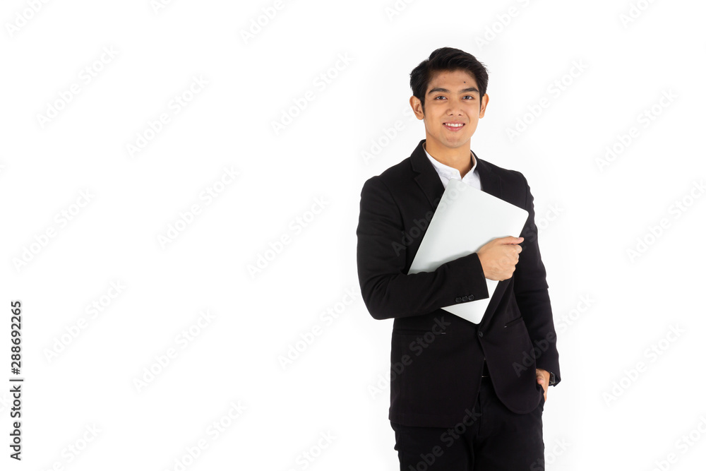 Handsome young businessman Asian caucasian wear a black suit with black hair, be a smile and standing smart poses. hold a computer laptop and use it. On a white background. Handsome young businessman Asian caucasian wear a black suit with black hair, be a smile and standing smart poses. hold a computer laptop and use it. On a white background.
