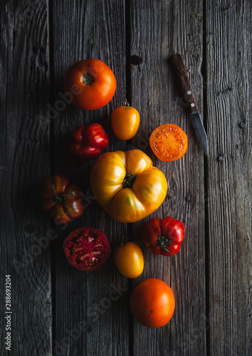 Ripe red tomatoes on a wooden background, healthy food, vegetables