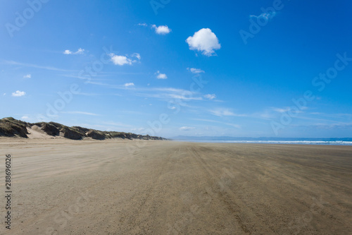 sand dunes and blue sky along the beach