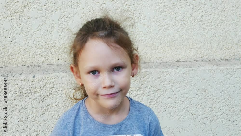 Portrait of a little girl on the background of the wall Portrait of a little girl on the background of the wall