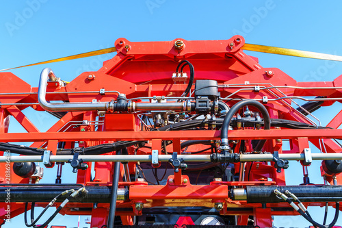 Hydraulic system, steel tubes, industrial tools equipment on agricultural machinery tractor or harvester, close up