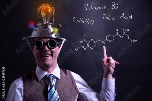 Nerd presenting handdrawn chemical formula of Vitamin B9