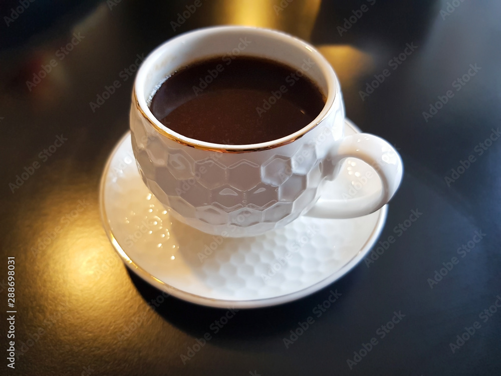 espresso coffee in white cap on black table espresso coffee in white cap on black table