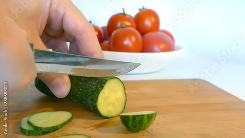 Сutting cucumber. Cooking vegetables with a knife.