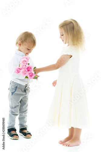A little boy gives a girl a bouquet of flowers. The concept of l
